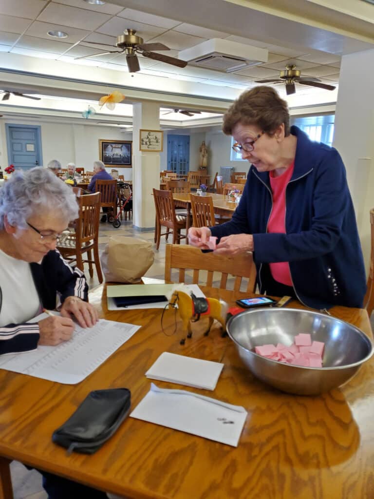 Sister Ann Patrice, left, makes a note of the horse chosen by Sister Mary Henning.
