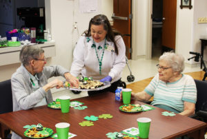 Sister Amanda Rose Mahoney, left, picks a treat off the snack cart held by Debbie Dugger, activities coordinator for the Villa, as Sister Mary Angela Matthews awaits her turn.