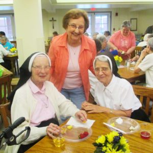 Enjoying some fruit and beverages are, from left, Sisters Emerentia Wiesner, Susan Mary Mudd and Rose Karen Johnson.