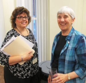 Martha Alle, left, director of Finance for the Ursuline Sisters and a new Ursuline Associate, chats with Sister Julia Head following her report to the community.