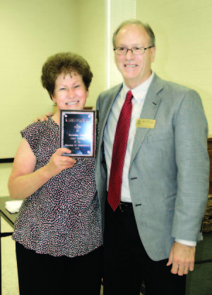 Sister Laurita Spalding holds her plaque Aug. 1 naming her Educator of the Year for 2014, presented to her by Jim Mattingly, superintendent of schools for the Diocese of Owensboro.