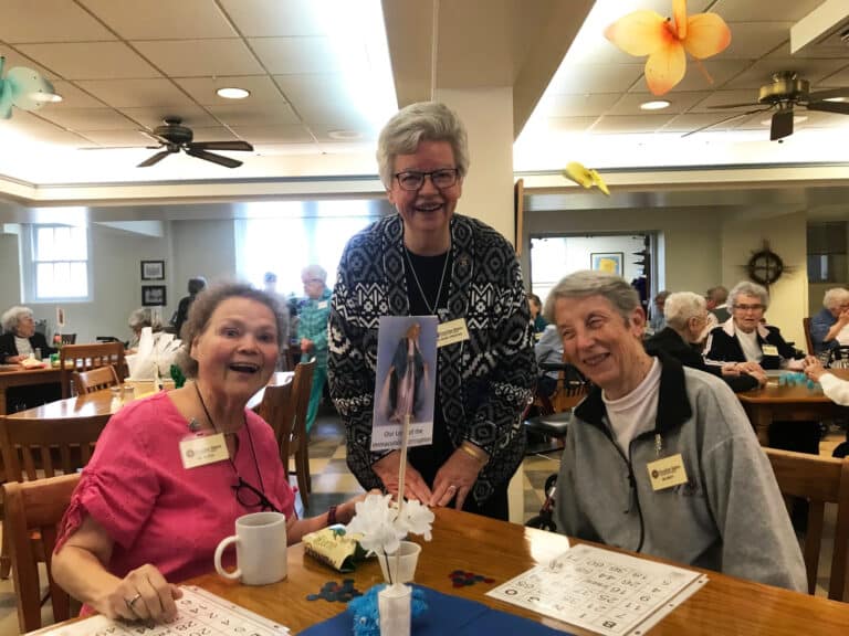 Sister Alicia Coomes, left, Sister Mary Timothy Bland, center, and Sister Maureen O’Neill smile during their bingo game.