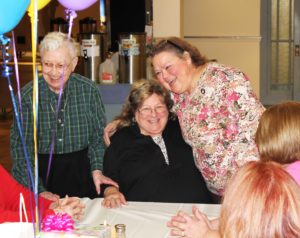 Sister Alicia Coomes, right, gives Debbie Rafferty a hug, as Sister Marie Bosco Wathen, left, smiles. Sister Alicia has served several stints working as a nurse at Maple Mount since Debbie was hired.