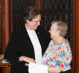 Sister Amelia Stenger receives congratulations from Sister Marie Joseph Coomes following Mass.