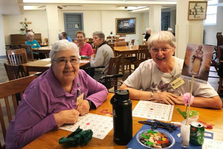 Sister Ann McGrew, left, and Sister Emma Anne Munsterman enjoy their time together. The two longtime friends joined the community together in 1965.