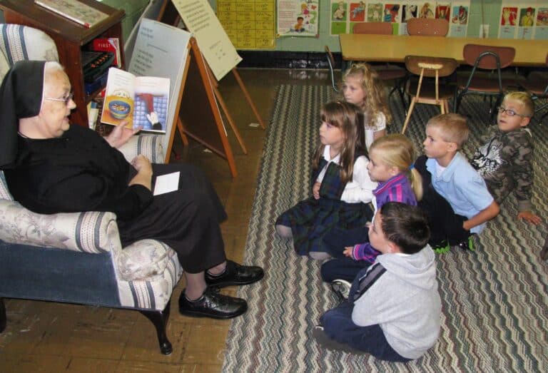 Sister Anne Michelle Mudd reads to kindergarten students at St. Paul School in this 2011 photo.