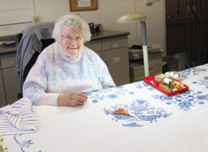 Sister Catherine Kaufman works on a quilt in the Motherhouse Craft Room on Jan. 8. The quilt, pieced by Sister Laurita Spalding, will be used in the Ursuline Sisters Quilt Club.