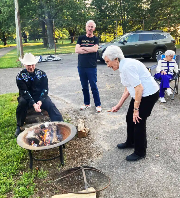A camp tradition each year was roasting marshmallows in the Mount Park to make s’mores. Here Sister Elaine Burke compares her roasting technique with Bryan Heath, as Michael Coonrod looks on. A camp tradition each year was roasting marshmallows in the Mount Park to make s’mores. Here Sister Elaine Burke compares her roasting technique with Bryan Heath, as Michael Coonrod looks on.