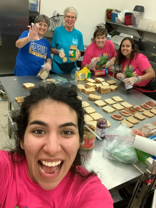 Sister Jacinta Powers, standing left, helps prepare peanut butter and jelly sandwiches at the Humanitarian Respite Center in McAllen, Texas, along with the other members of the “Bridges at the Border” immersion team. Standing next to Sister Jacinta is Sister Norma Raupple, an Ursuline Sister of Youngstown, Ohio, who led the experience.