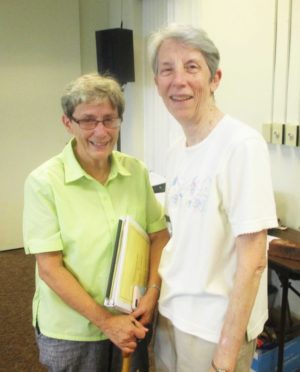 Sister Judith Nell Riney, left, and Sister Maureen O’Neill pause for a moment between meetings.