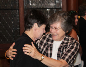 Sister Kathleen Condry, left, gets a congratulatory hug from Sister Cheryl Clemons.
