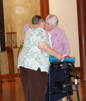 Sister Pat Lynch, right, hugs Sister Kathleen Dueber after giving her a quilt. The two served in leadership together when they were Ursuline Sisters of Paola, Kan.