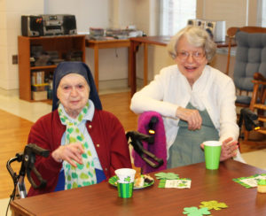 Sister Marie William Blyth, left, and Sister Catherine Barber enjoy the festivities, which coincided with the NCAA basketball tournament on TV.
