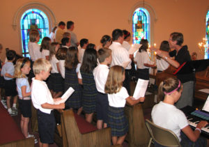 Students of all ages sing under the direction of Sister Marilyn Mueth at the opening school Mass on Aug. 21, 2009, at St. James School in Millstadt, Ill. 