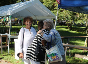 Sister Mary Sheila Higdon, far right, is hugged by twin sisters Jean Carrico and Jan Gish at the picnic.