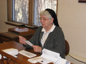Sister Michael Ann going through paperwork in the community business office in February 2013. She volunteers in the office in the afternoons.