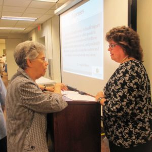 Sister Nancy Murphy, left, speaks with Martha Alle, director of Finance, following Martha’s presentation to the sisters July 12.