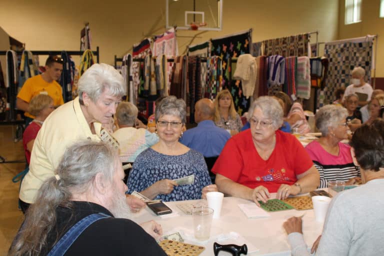 Sister Pam Mueller, left, sells bingo cards to this table of players.