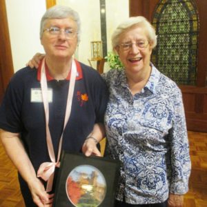 Sister Rita Scott, left, poses with her present along with Sister Eva Boone.