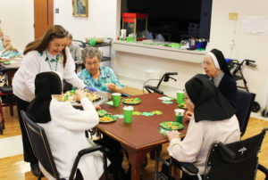 It’s always service with a smile from Debbie Dugger as she serves a treat to Sister Emma Cecilia Busam. Around the table from left are Sister Ruth Mattingly, Sister Helen Leo Ebelhar and Sister Pauletta McCarty.