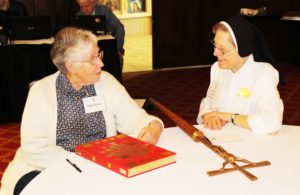Sister Ruth Gehres, left, of Mount Saint Joseph, talks with Sister Mary Jo Gramig, an Ursuline of Louisville prior to Mass on July 9. Sister Mary Jo carried in the cross, while Sister Ruth carried the Lectionary. Sister Ruth’s mother was friends with Sister Mary Jo’s aunt, but the two sisters hadn’t seen each other in many years.