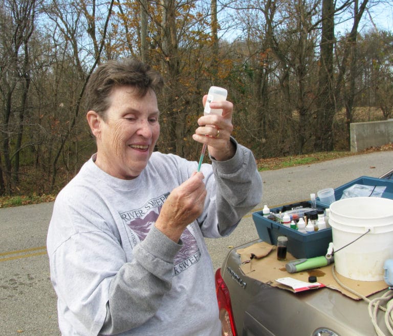 Sister Sharon Sullivan tests a water sample taken from a Daviess County creek in 2013 as part of her role in Watershed Watch.