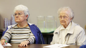 Ursuline Sisters Cecelia Joseph Olinger, left, and Alfreda Malone listen to Sister Vivian.