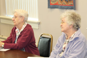 Ursuline Sisters Eva Boone and Francis Louise Johnson give thought to a comment from Sister Vivian.