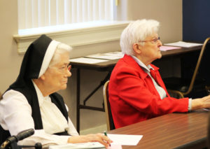 Ursuline Sisters Joseph Angela Boone, left, and George Mary Hagan are engrossed in Sister Vivian’s presentation.