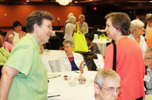 Sister Sharon Sullivan, left, who concludes her term as congregational leader of the Ursulines of Mount Saint Joseph on July 16, 2016, greets Sister Lynn Jarrell, the past president of the Ursulines of Louisville.