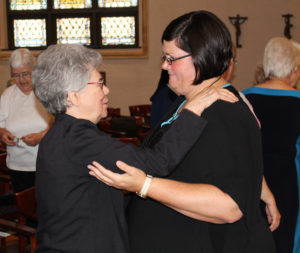 Sister Nancy Murphy hugs Sister Stephany following her entrance.