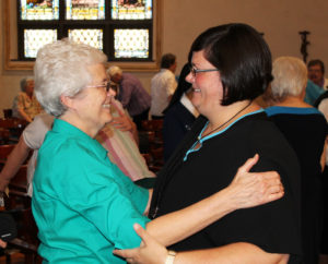 Sister Barbara Jean Head, left, was one of many sisters to congratulate Sister Stephany following her entrance.