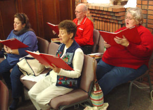 Sister Joan Riedley, front right, sings during practice with the St. Denis choir in 2008. 
