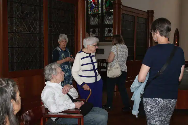 Sister George Mary Hagan, standing next to a seated Mary Ford Vuncannon, offers to answer any questions the visitors may have. Sister George Mary Hagan, standing next to a seated Mary Ford Vuncannon, offers to answer any questions the visitors may have.