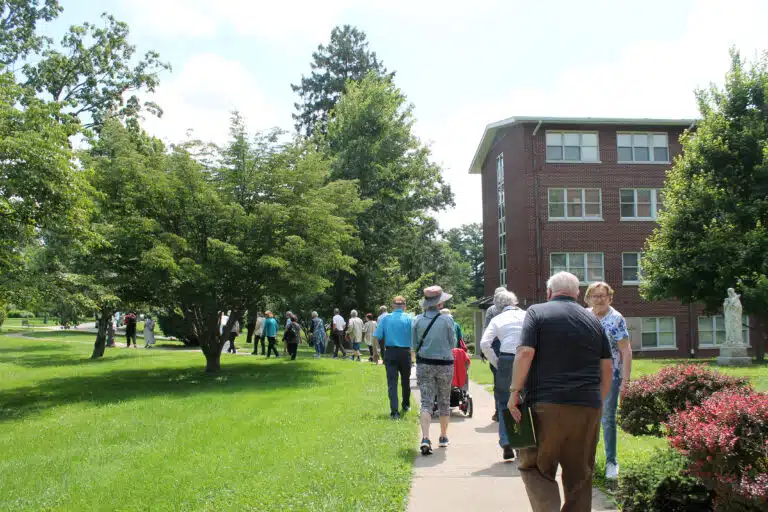 Visitors from Louisville stroll across the sidewalk near the St. Ursula building. Visitors from Louisville stroll across the sidewalk near the St. Ursula building.