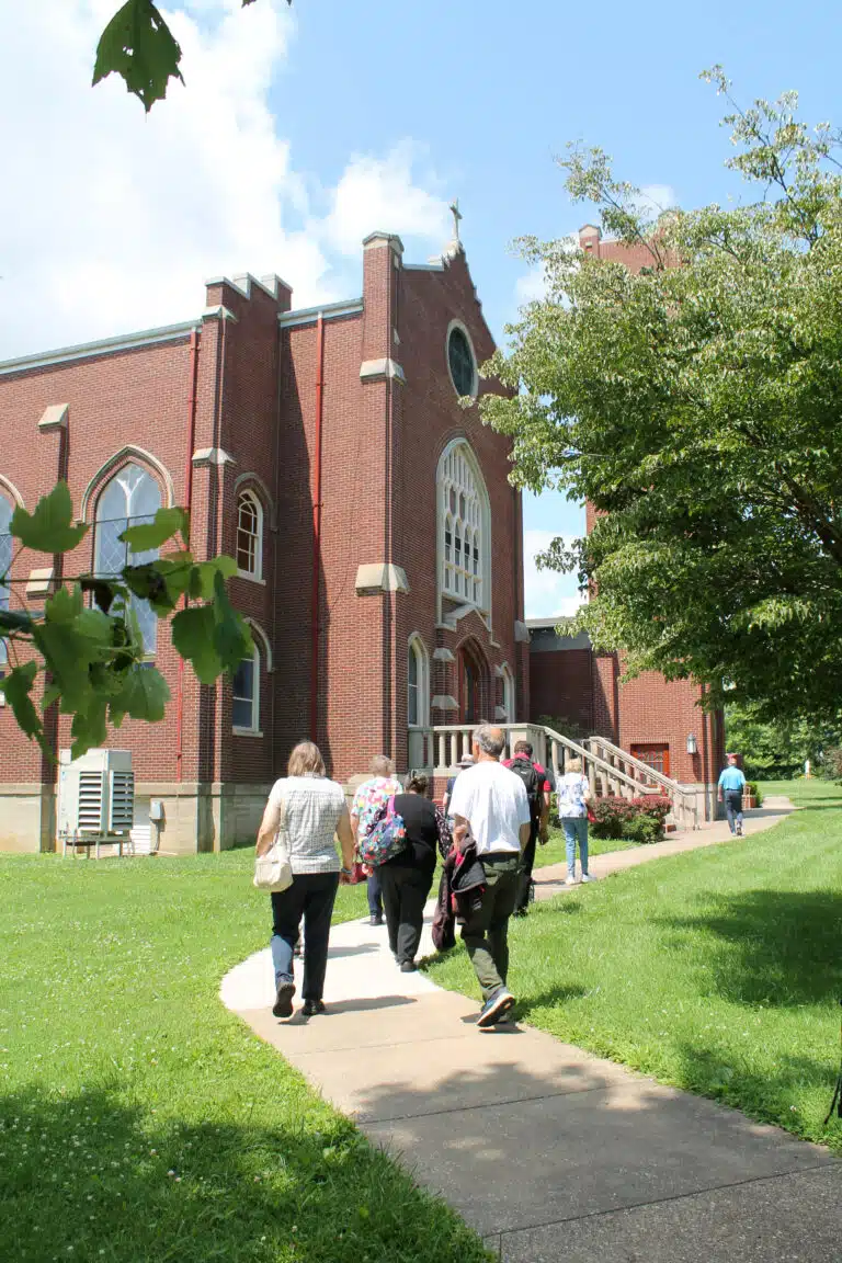 Visitors walk toward the Chapel on a sunny day in June. Visitors walk toward the Chapel on a sunny day in June.