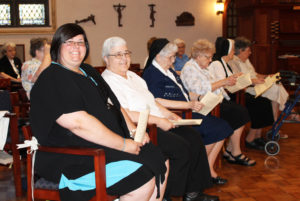 Sister Stephany Nelson, left, smiles as she is joined by Sister Ann McGrew, director of Novices, whom she will work with the next two years. To Sister Ann’s left are the four sisters who will make up Sister Stephany’s Formation Community – Sisters Michael Ann Monaghan, Mary Sheila Higdon, Joseph Angela Boone and Luisa Bickett.
