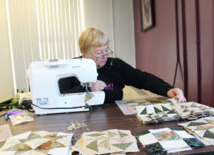 Tish Rudd, coordinator of the Trigg County Quilters, works on some pieces of a quilt border. “Several people bring UFOs – unfinished objects,” Rudd said.