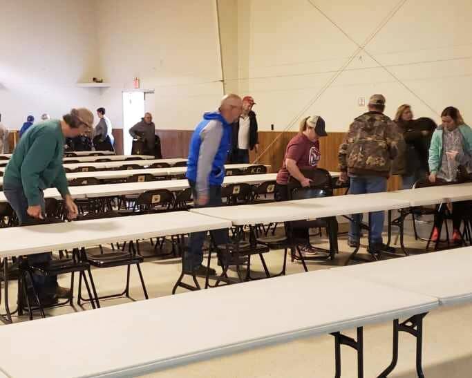 St. Jerome parishioners move tables on Saturday, Dec. 11, 2021, to one side of the parish hall to create an eating area for tornado victims, while clearing the opposite side for a sleeping area.