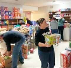 Supplies of food and other items get organized at the St. Jerome parish hall.