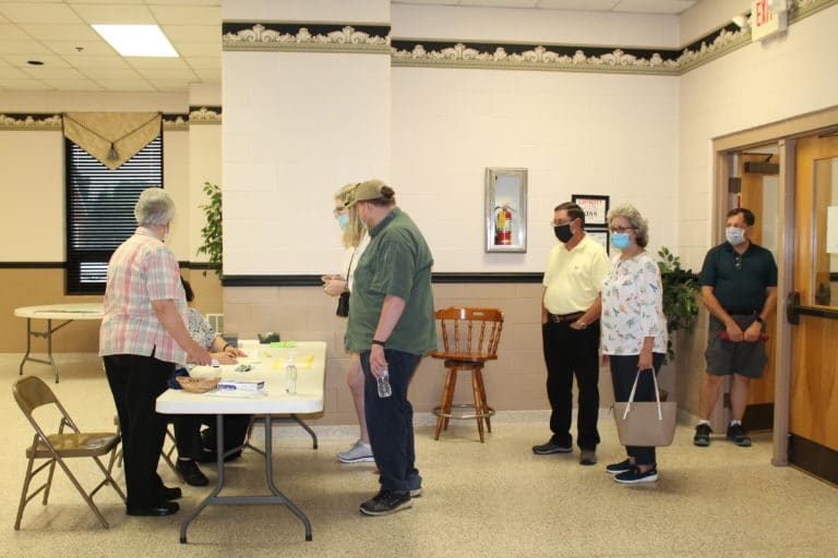 Participants line up to sign in at the Immaculate Parish Hall prior to the start of Trivia Night at 6 p.m.