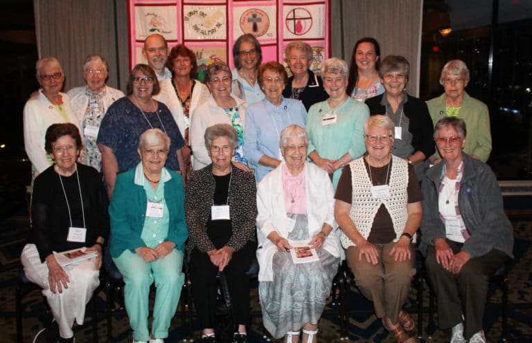 The 19 Ursuline Sisters and Associates from Mount Saint Joseph gathered for a photo following the banquet July 27. Seated, from left, are Sisters Mary Henning, Cecelia Joseph Olinger, Nancy Murphy, Marcella Schrant, Suzanne Sims and Mary Ellen Backes; standing, from left, are Associate Janice Arth, Sister Ruth Gehres, Associate Joanne Thompson, Associate Dan Heckel, Associate Doreen Abbott, Associate Karen Siciliano, Sister Larraine Lauter, Sister Elaine Burke, Sister Michele Morek, Sister Pam Mueller, Associate Renee Schultz, Sister Cheryl Clemons and Sister Angela Fitzpatrick.