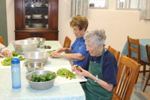 Sister Elaine Burke, left, and Sister Marietta Wethington cut up green peppers in the small dining room.