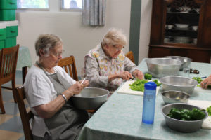 Sister Marie Joseph Coomes, left, and Sister Mary Sheila Higdon help dice green peppers for the coleslaw that will feed hundreds of people at the picnic.