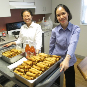 Sister Anh Tran, left, and Sister Huyen Vu stand over their delicacies. The sisters are beginning their third semester at Brescia University this fall.
