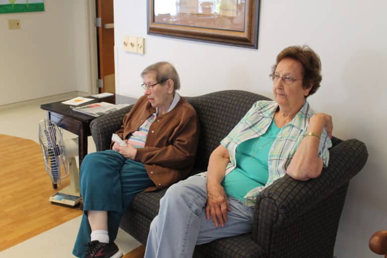 Sister Susanne Bauer, left, and Sister Susan Mary Mudd watch the program.