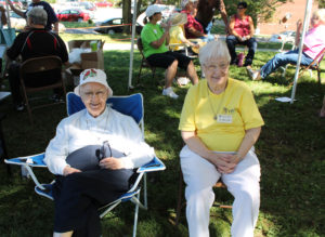Sister Marie Bosco Wathen, left, and Sister Marcella Schrant smile as they sit near the Welcome Booth.