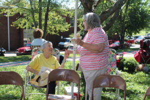 Sister Marietta Wethington, left, greets Patty Mills (Sister Michael Ann Monaghan's niece) beside the Welcome and “Visit a Sister” booth at the picnic.