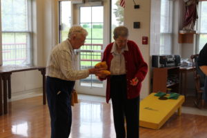 Sister Marie Bosco Wathen hands the bean bags to Sister Clarence Marie Luckett.