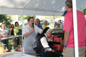 Congregational Leader Sister Amelia Stenger, left, calls out the names of the winning raffle ticket winners after they are drawn by Sister Joseph Angela Boone. Sister Joseph Angela was one of the sisters who first planned a Mount Saint Joseph Picnic.